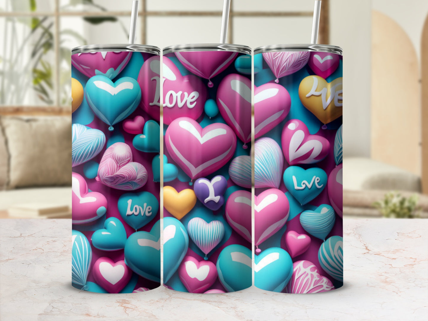 Three heart-patterned tumblers with straw, set against a blurred background.