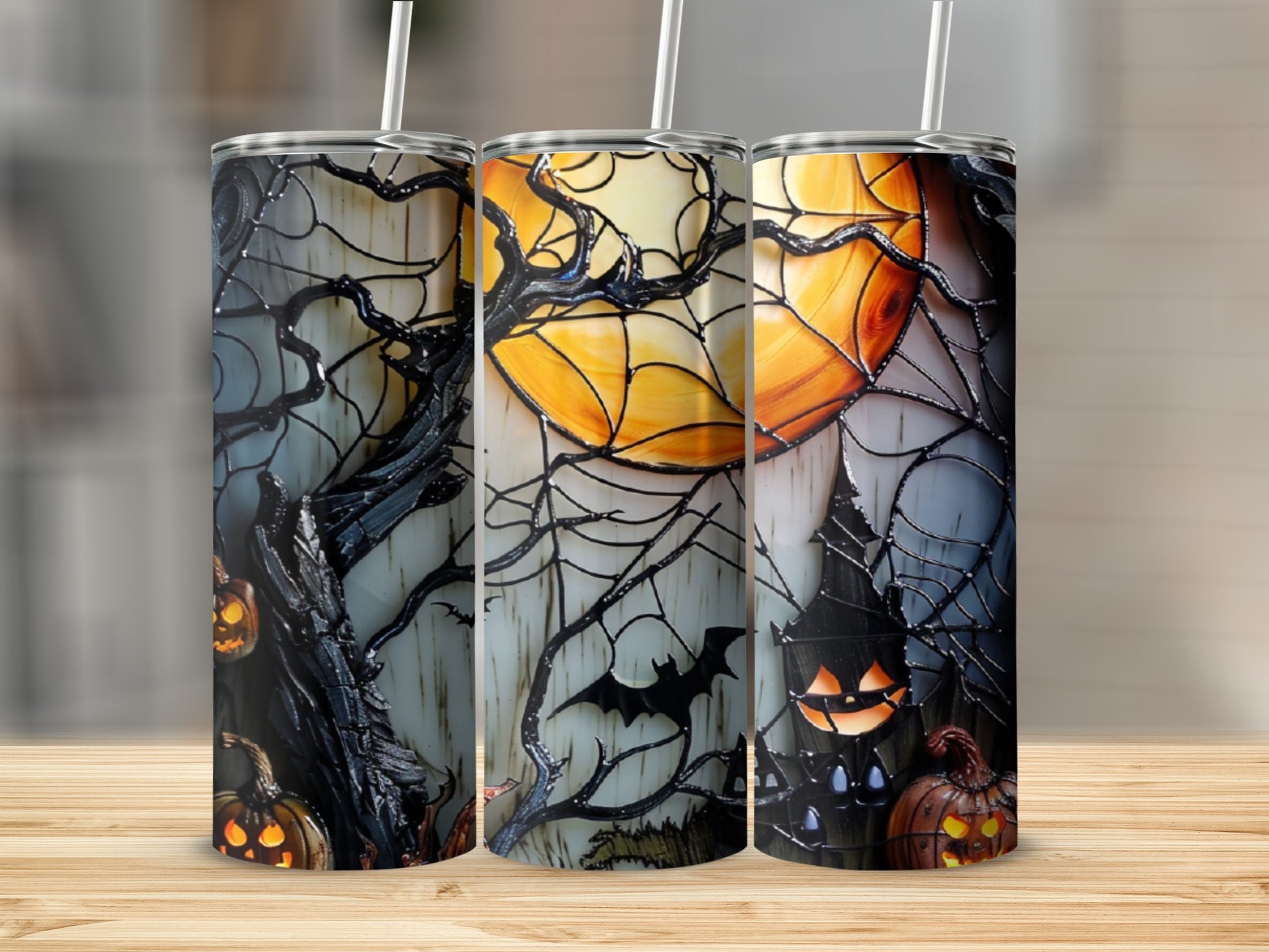Halloween tumbler with jack-o'-lanterns, moon, and bat on a wooden surface.