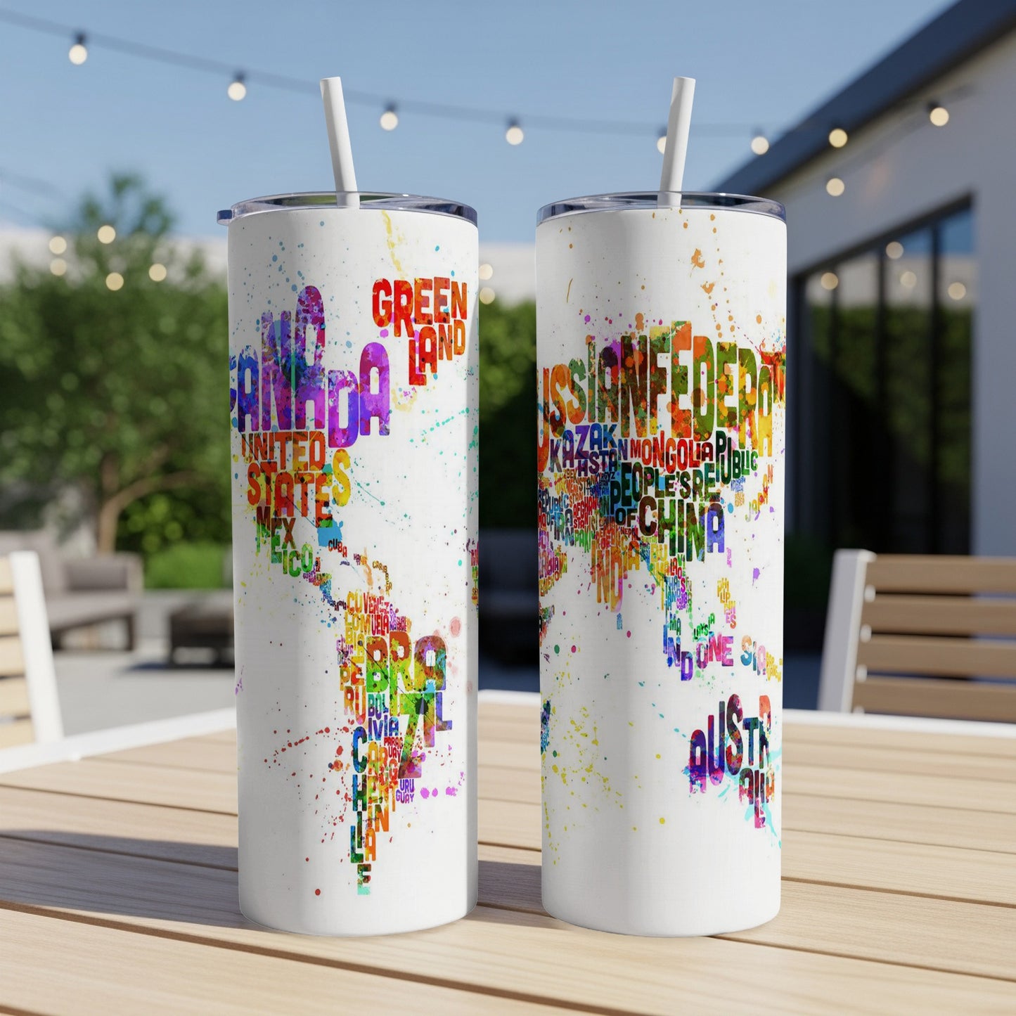 Two white tumblers with country names in colorful paint splatters, including Canada, USA, and Russia.