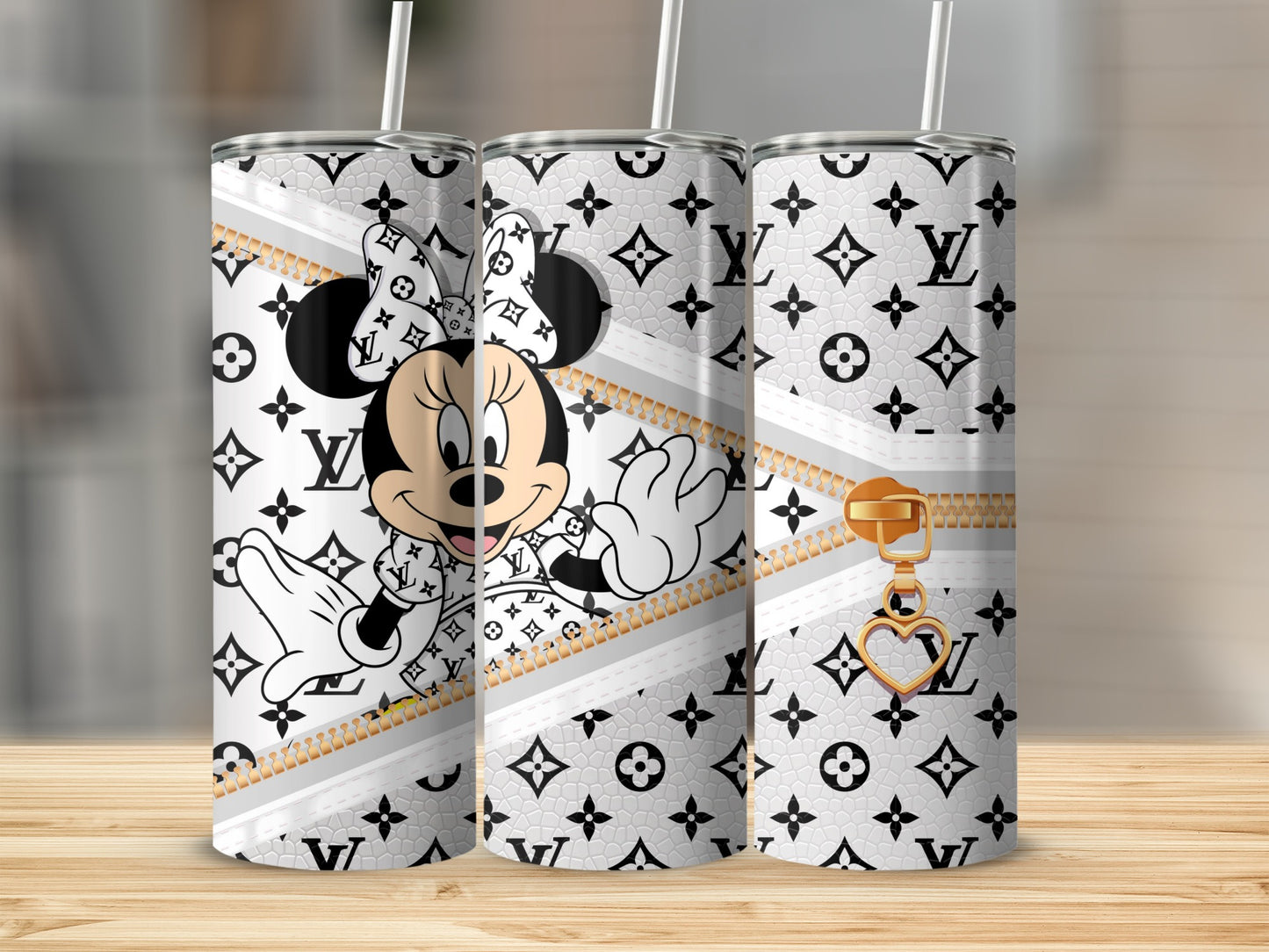 Minnie Mouse with Louis Vuitton-inspired pattern and gold zipper detail on three tumblers.