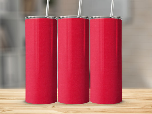 Three red tumblers with white straws on a wooden surface.