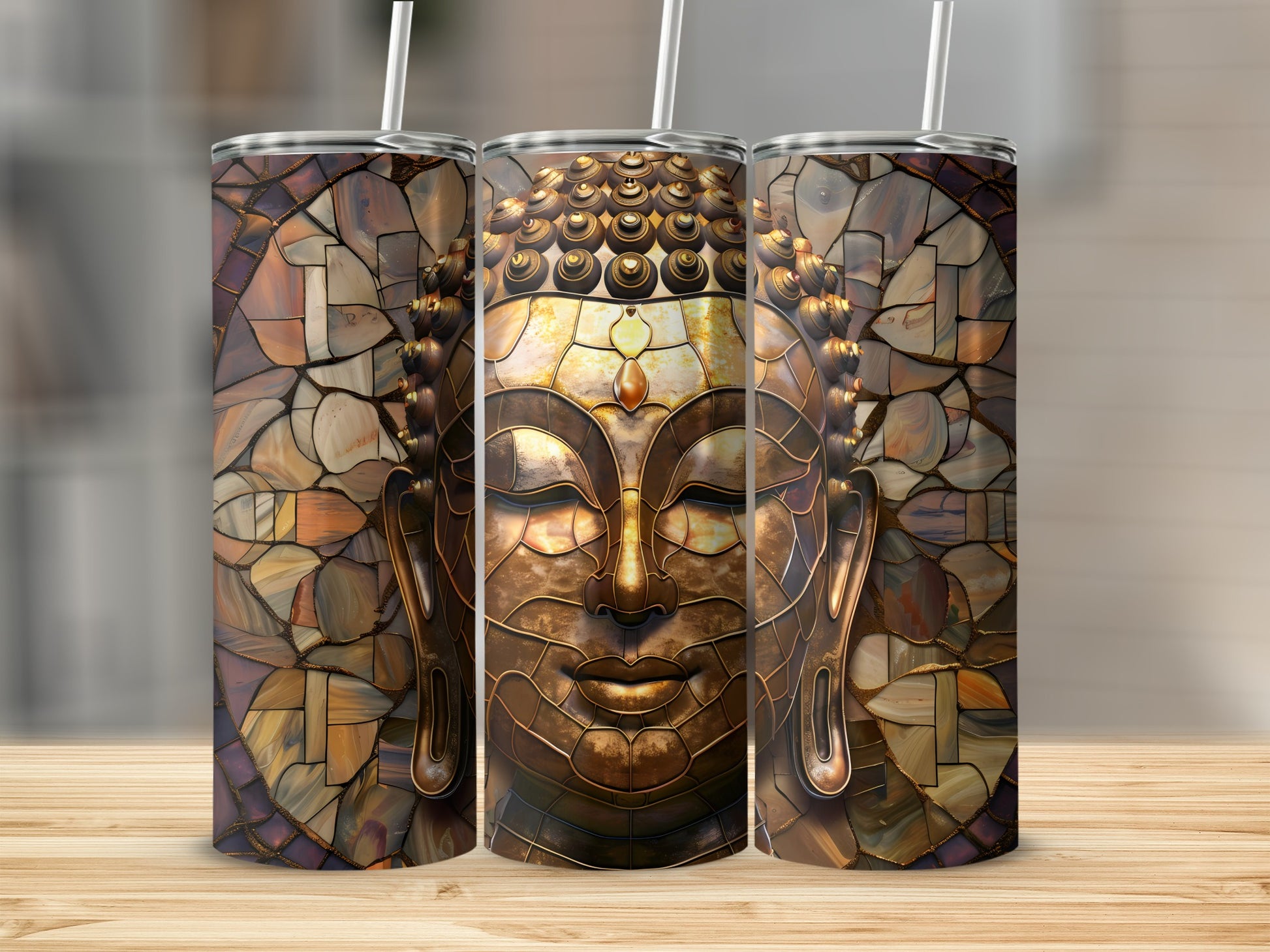 Three tumblers with a mosaic Buddha face design.
