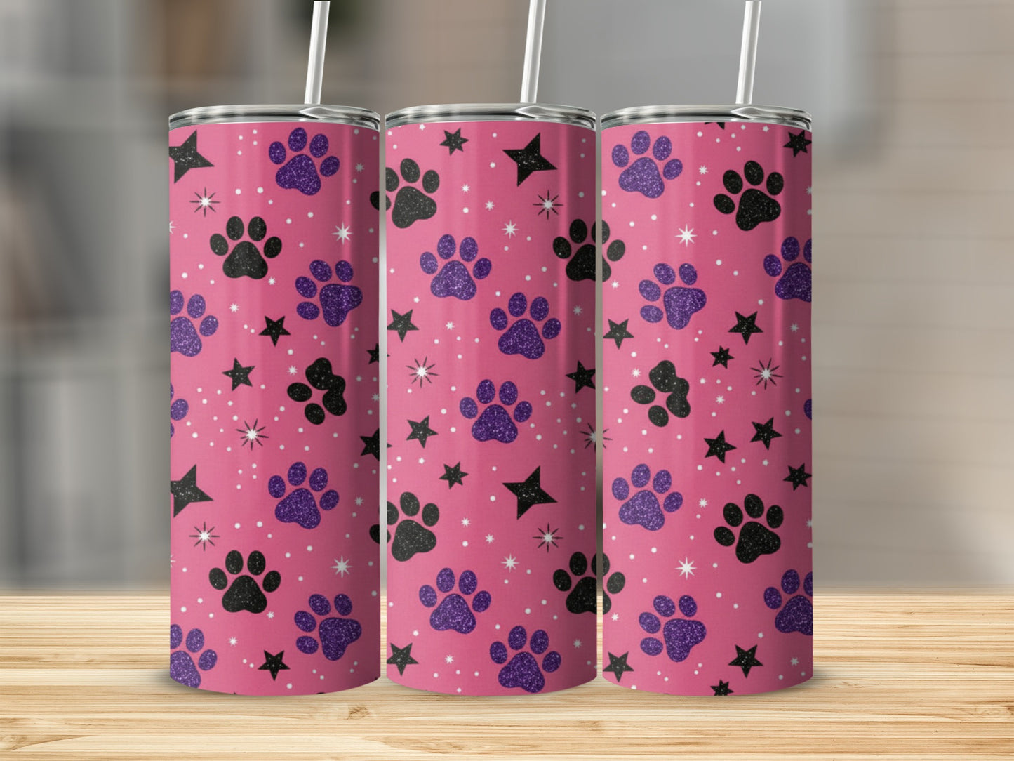 Pink tumbler with purple paw prints and black stars pattern.