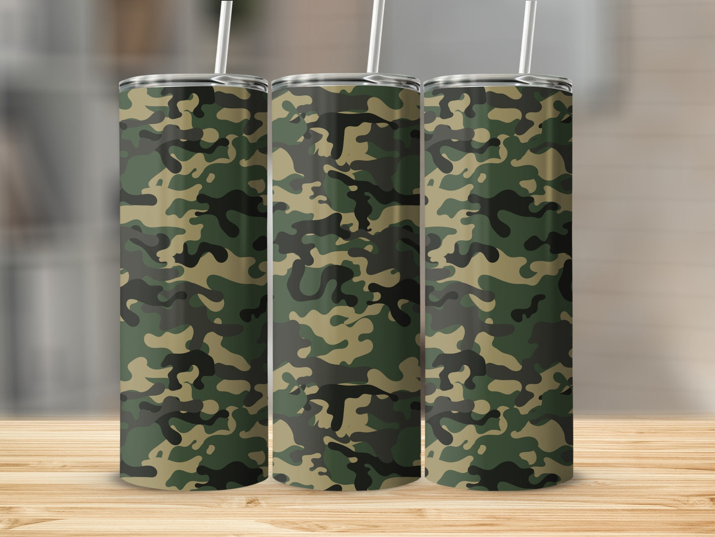 Three stainless steel tumblers with a green and tan camouflage pattern.