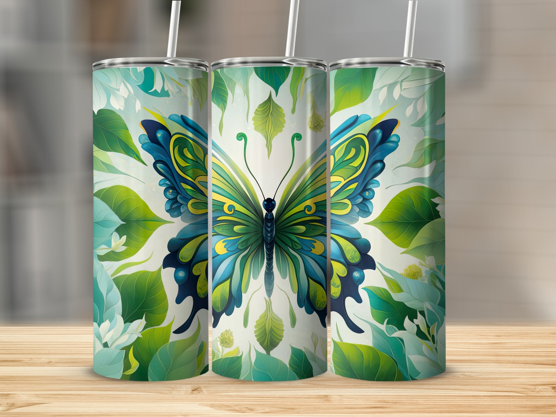 Three tumblers featuring a large blue and yellow butterfly with green leaves.