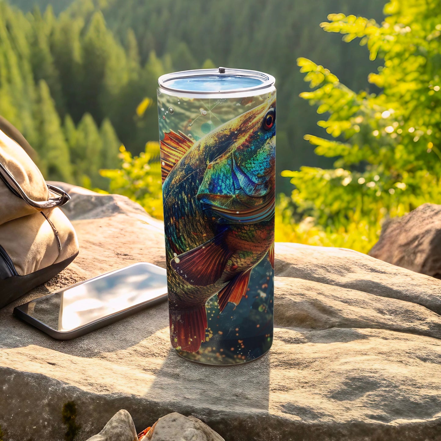 Tumbler with a detailed, colorful fish illustration on a rocky outdoor surface.