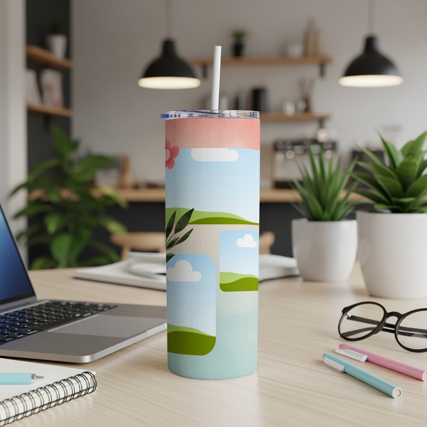 Tumbler with whimsical landscape illustration, clouds, and a pink flower.