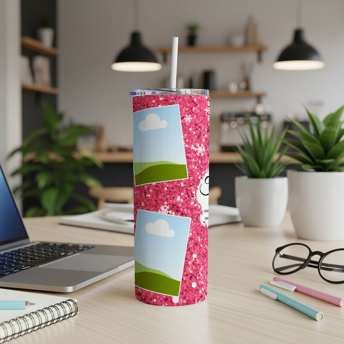 Pink glitter tumbler with photos, snowflakes, and text on a desk.