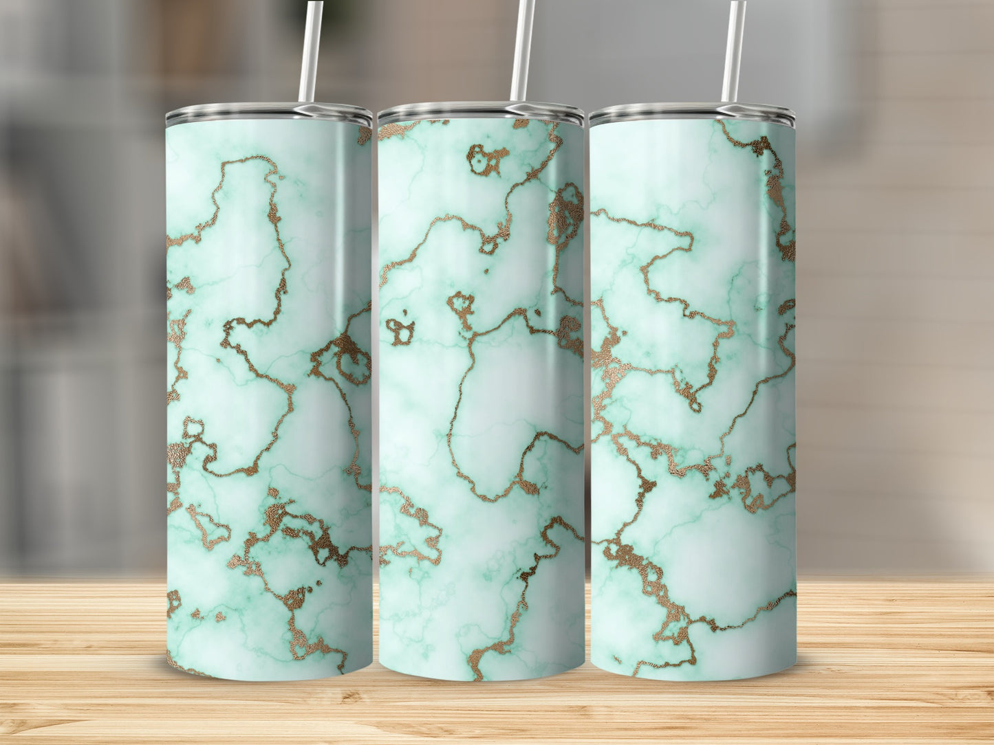 Three tall tumblers with a mint green marble and gold veined pattern.