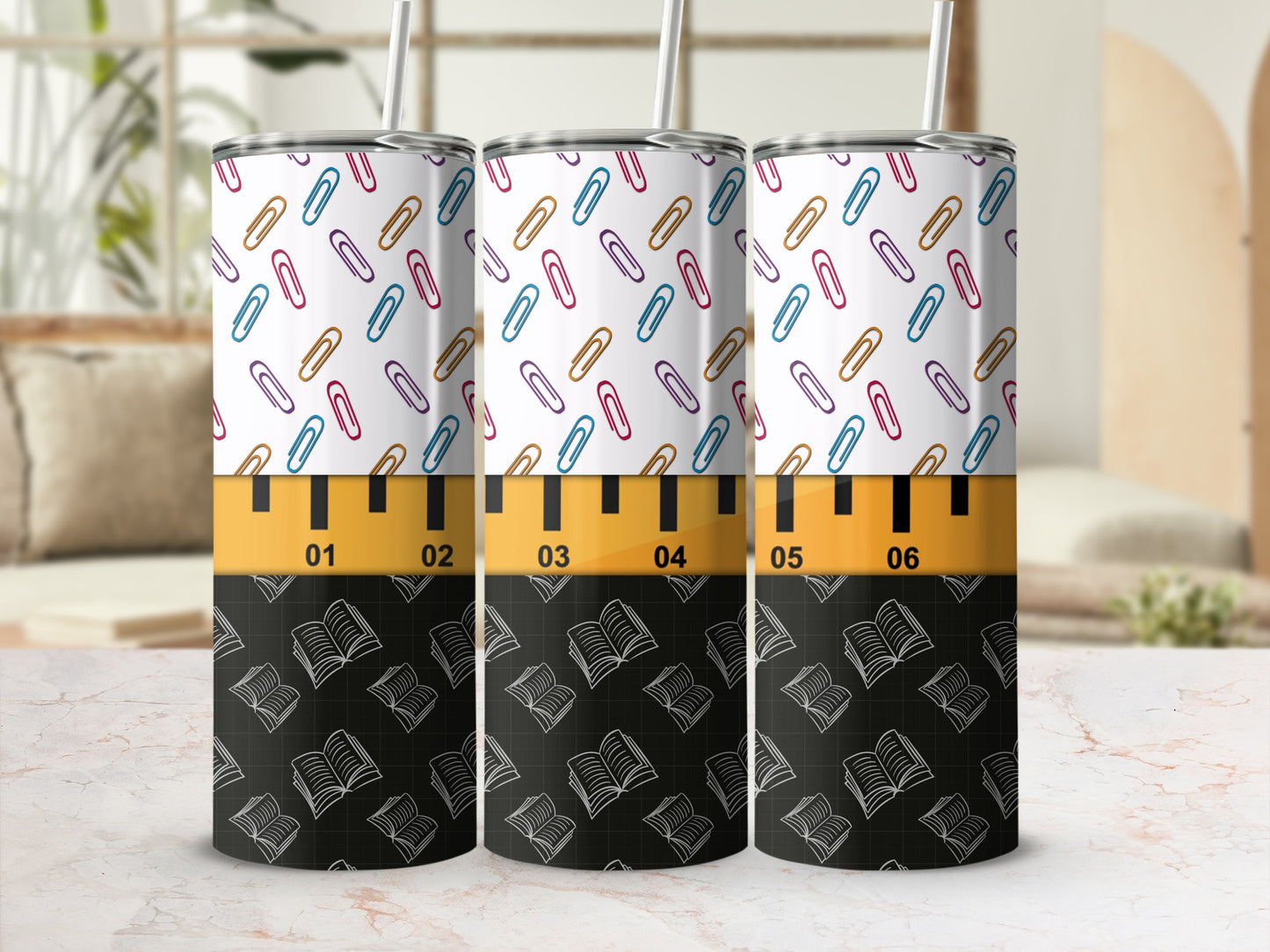 Tumbler with colorful paperclips and open books pattern, marked with ruler lines.