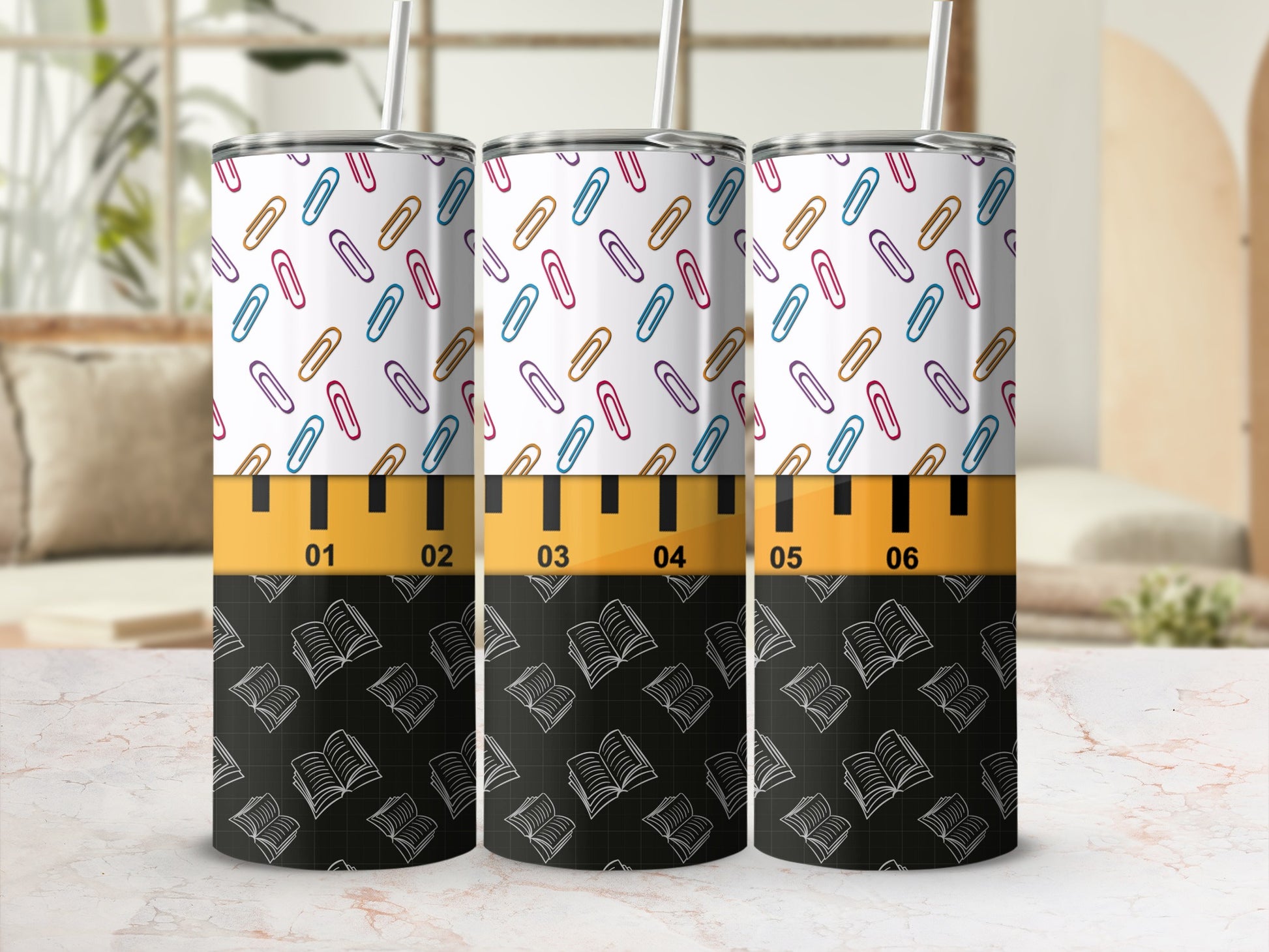 Tumbler with colorful paperclips and open books pattern, marked with ruler lines.