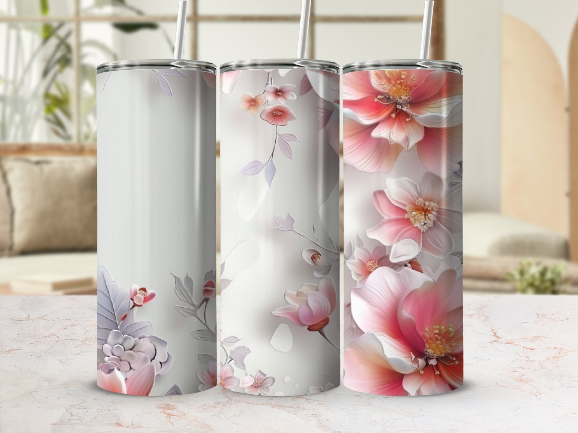 Three tumblers with delicate floral designs, one blank, two with pink and purple flowers.