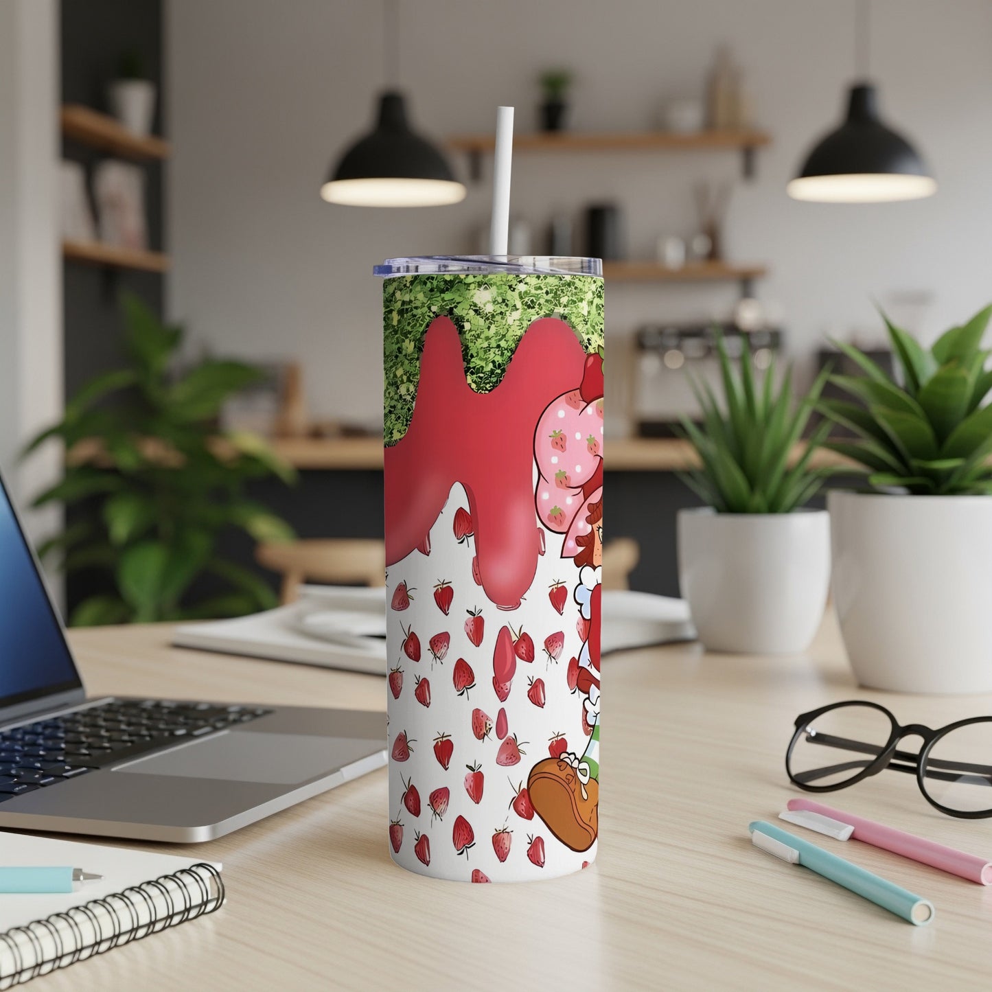 Tall tumbler with strawberry and glitter design.