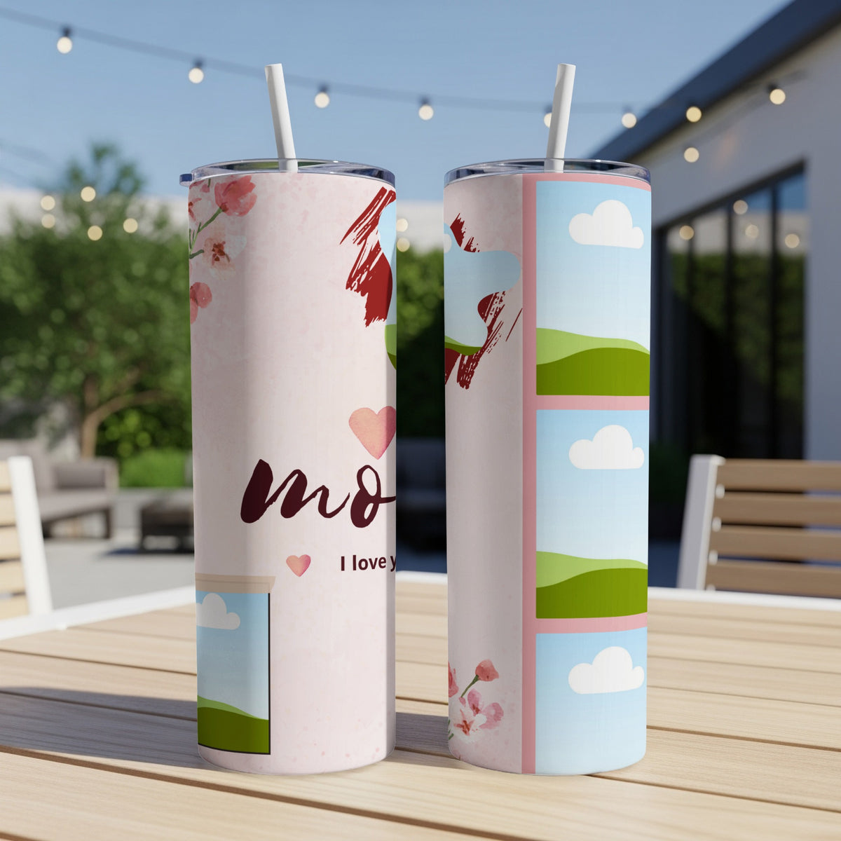 Two tumblers with pink floral and sky designs, one saying "mom I love y".