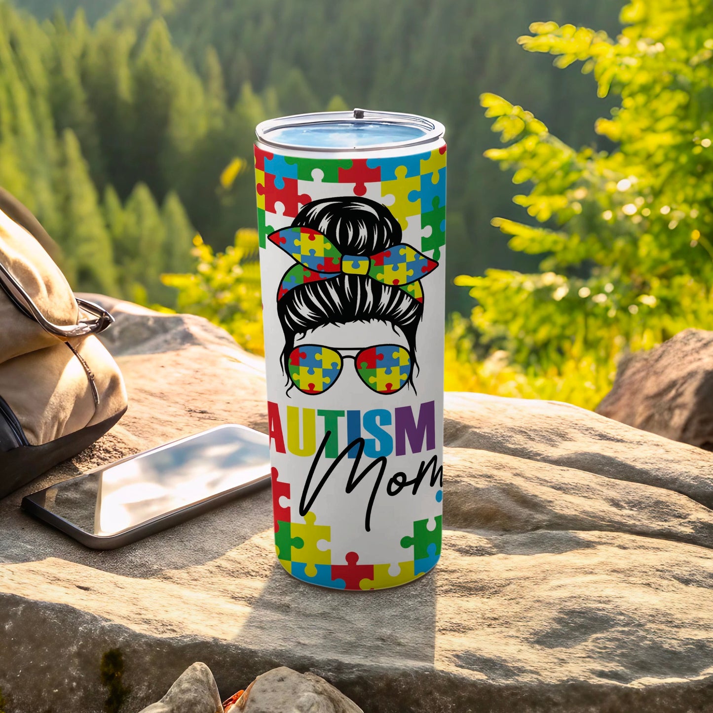Autism Mom tumbler with puzzle piece design and messy bun graphic.