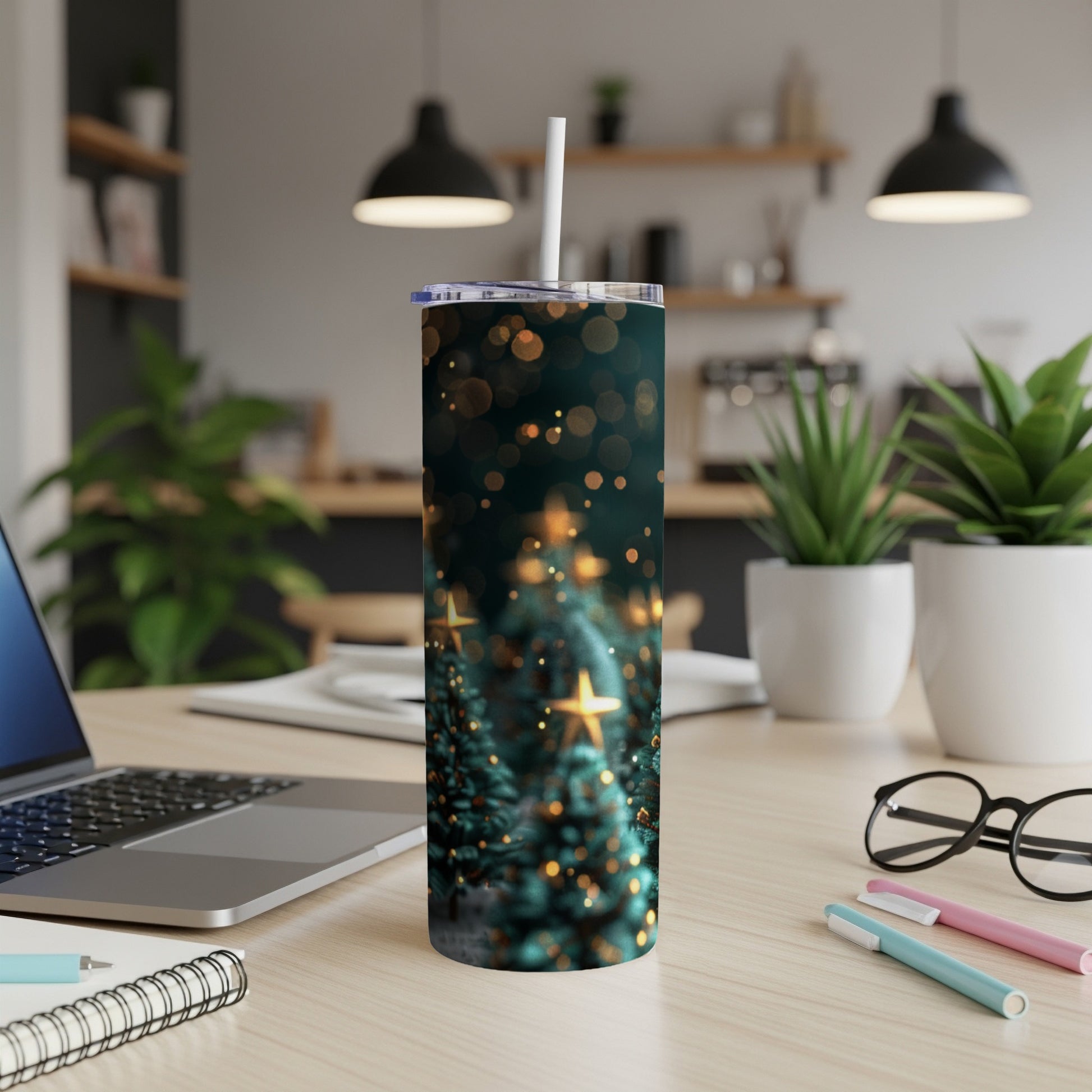 Tumbler with blurred Christmas trees and bokeh lights on a desk.