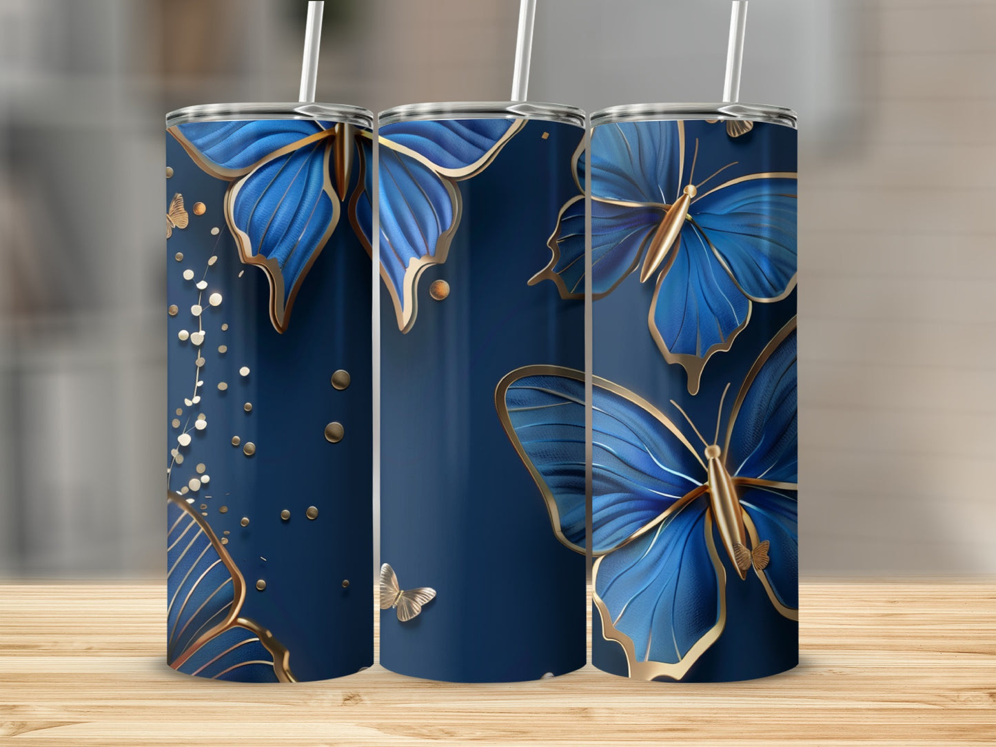 Three navy blue tumblers with golden butterflies and confetti designs.