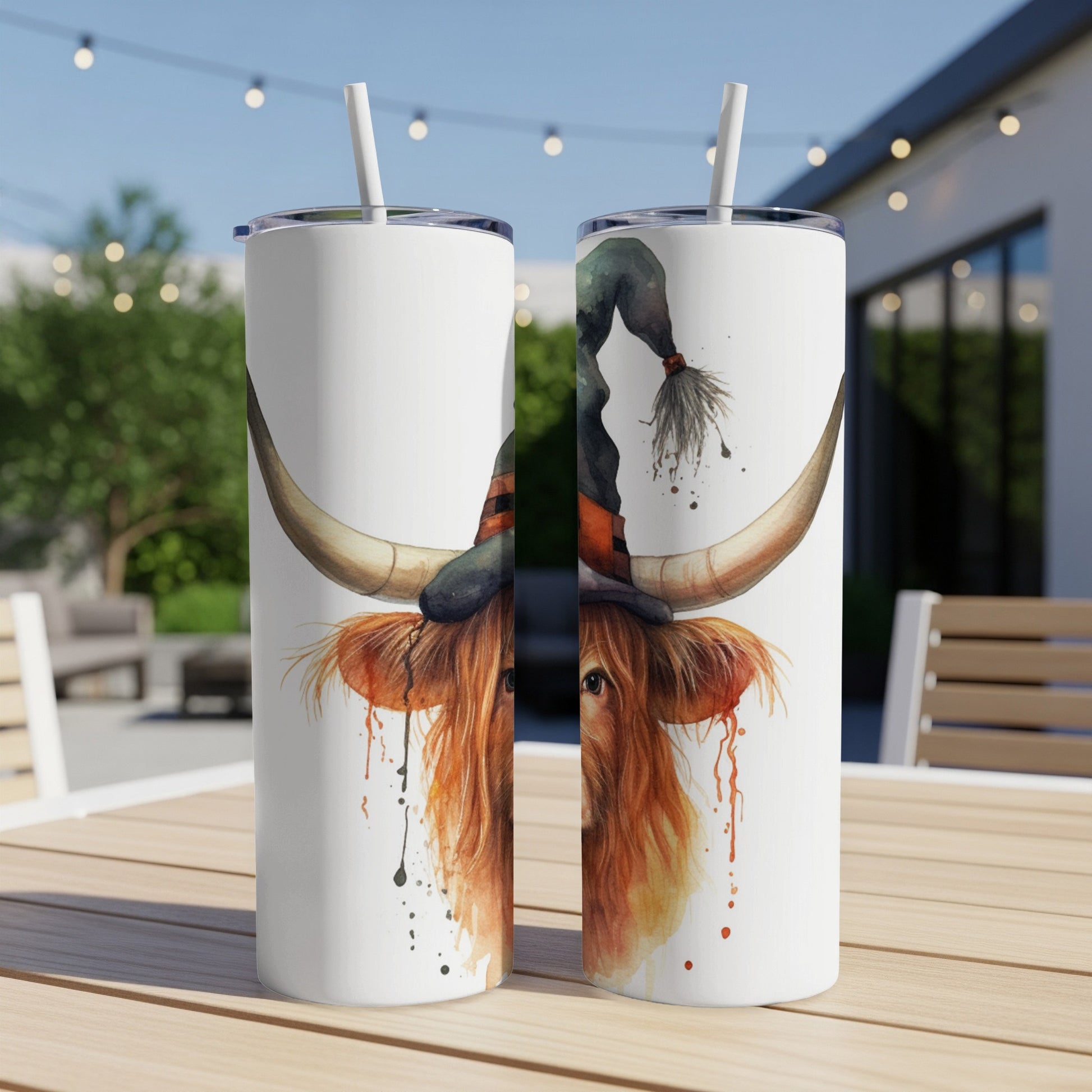 Highland cow wearing a witch hat, digital art on a white tumbler.