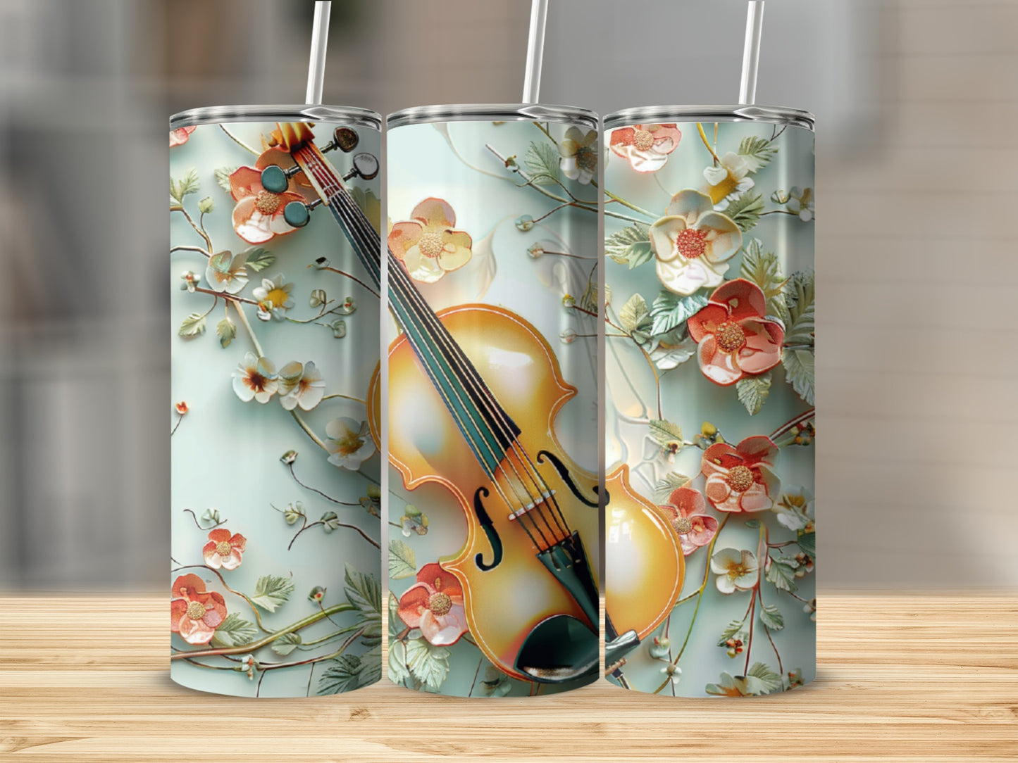 Three tumblers with a violin and floral design on a wooden surface.
