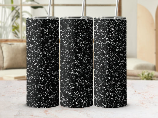 Three black glitter tumblers with white speckles on a marble surface.