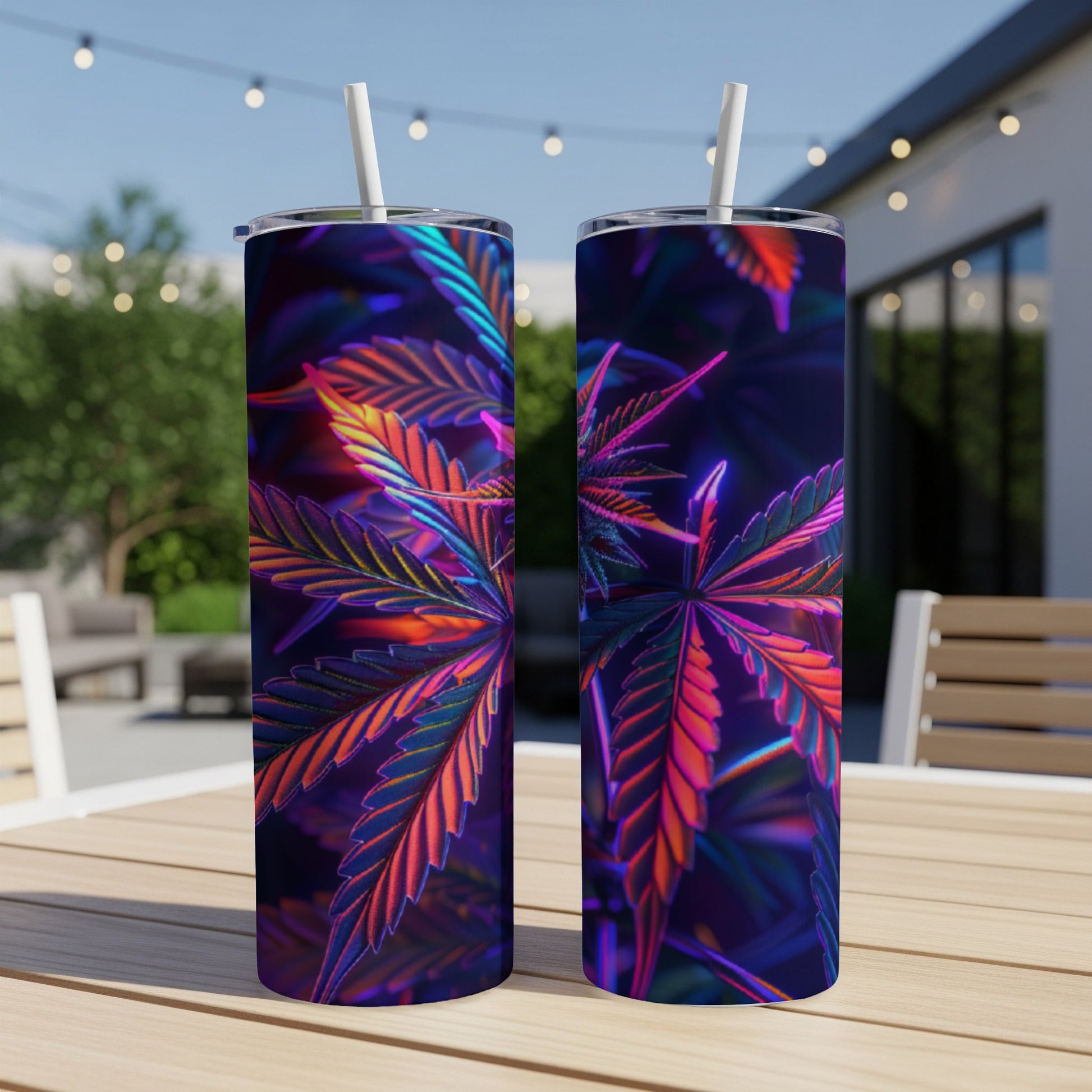 Two tumblers with a neon cannabis leaf design on a patio table.