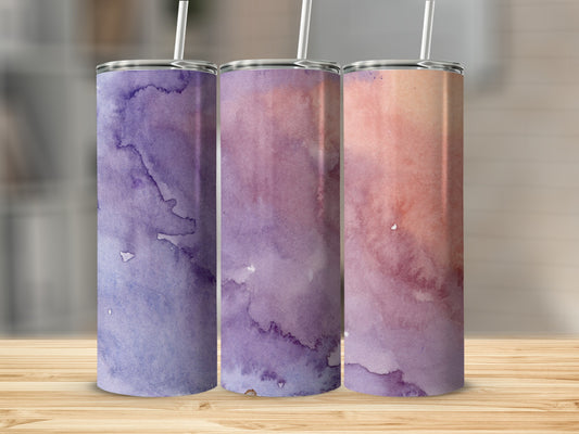 Three tumblers with watercolor designs in purple and pink hues.