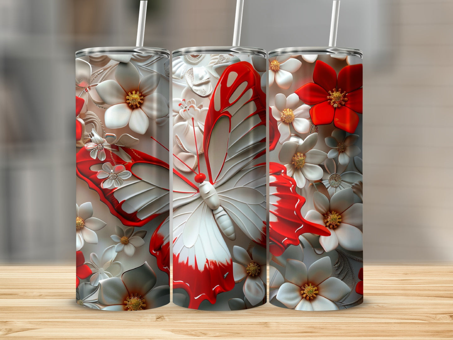 Three tumblers with red and white butterfly and floral relief designs.