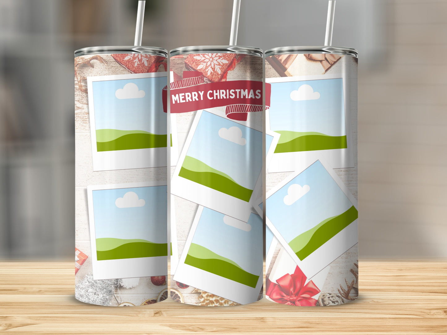 Three tumblers with holiday photos and "Merry Christmas" banner on wooden surface.