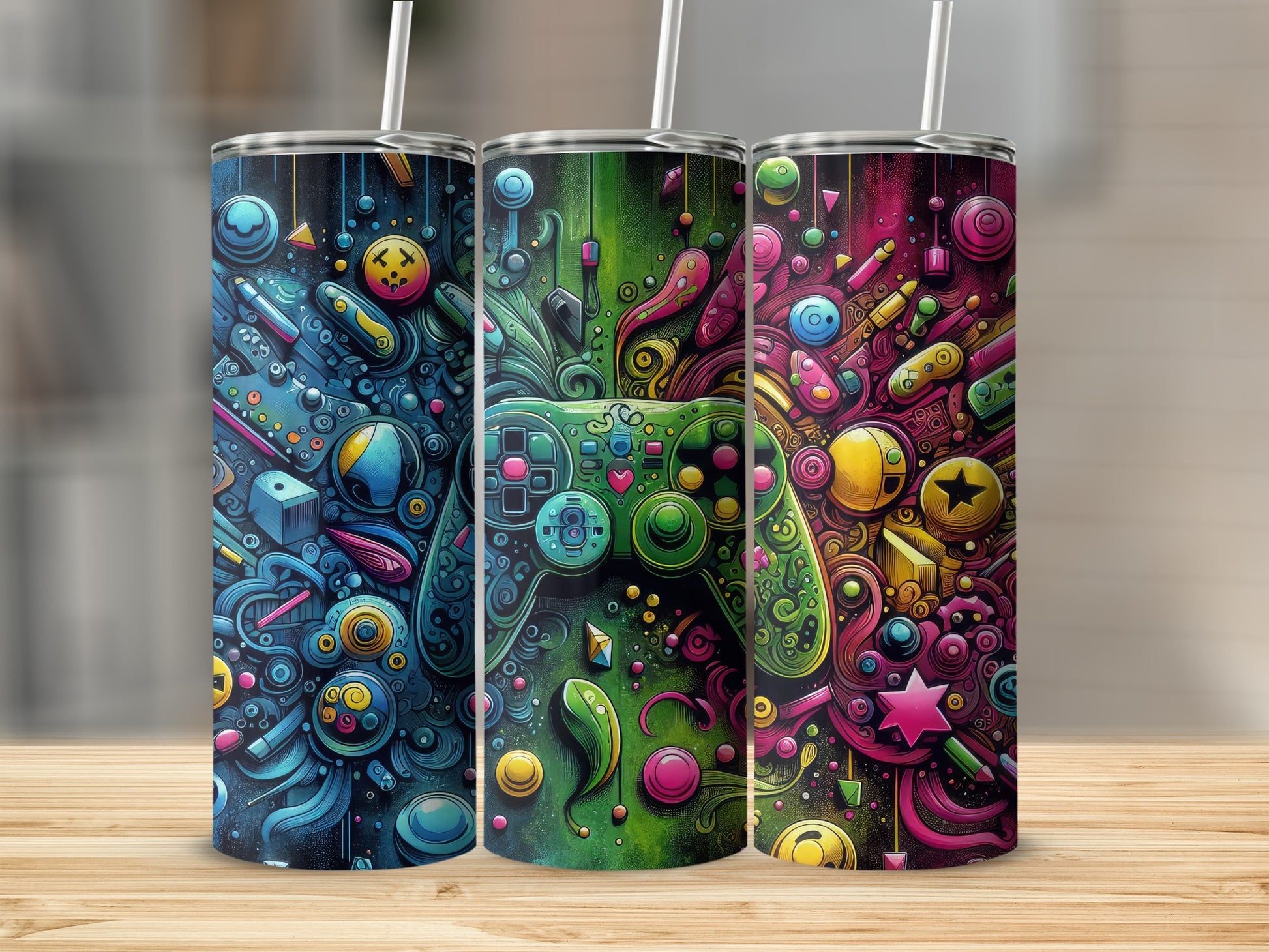 Three colorful tumblers with a vibrant video game controller and pop art design.