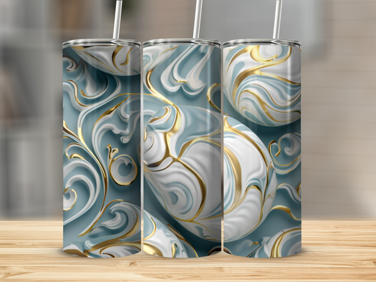 Three tumblers with a swirling blue, white, and gold ornate design.