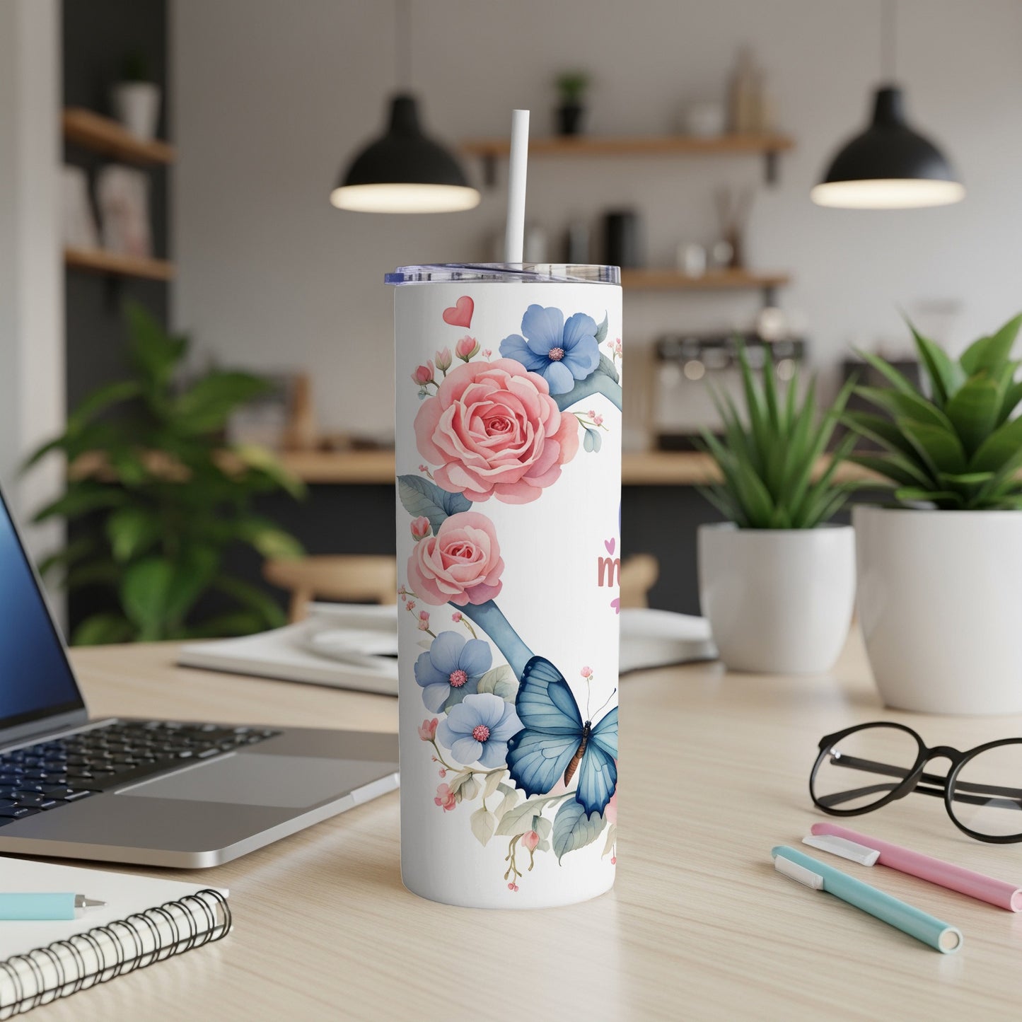 White skinny tumbler with pink roses, blue flowers, and a butterfly.
