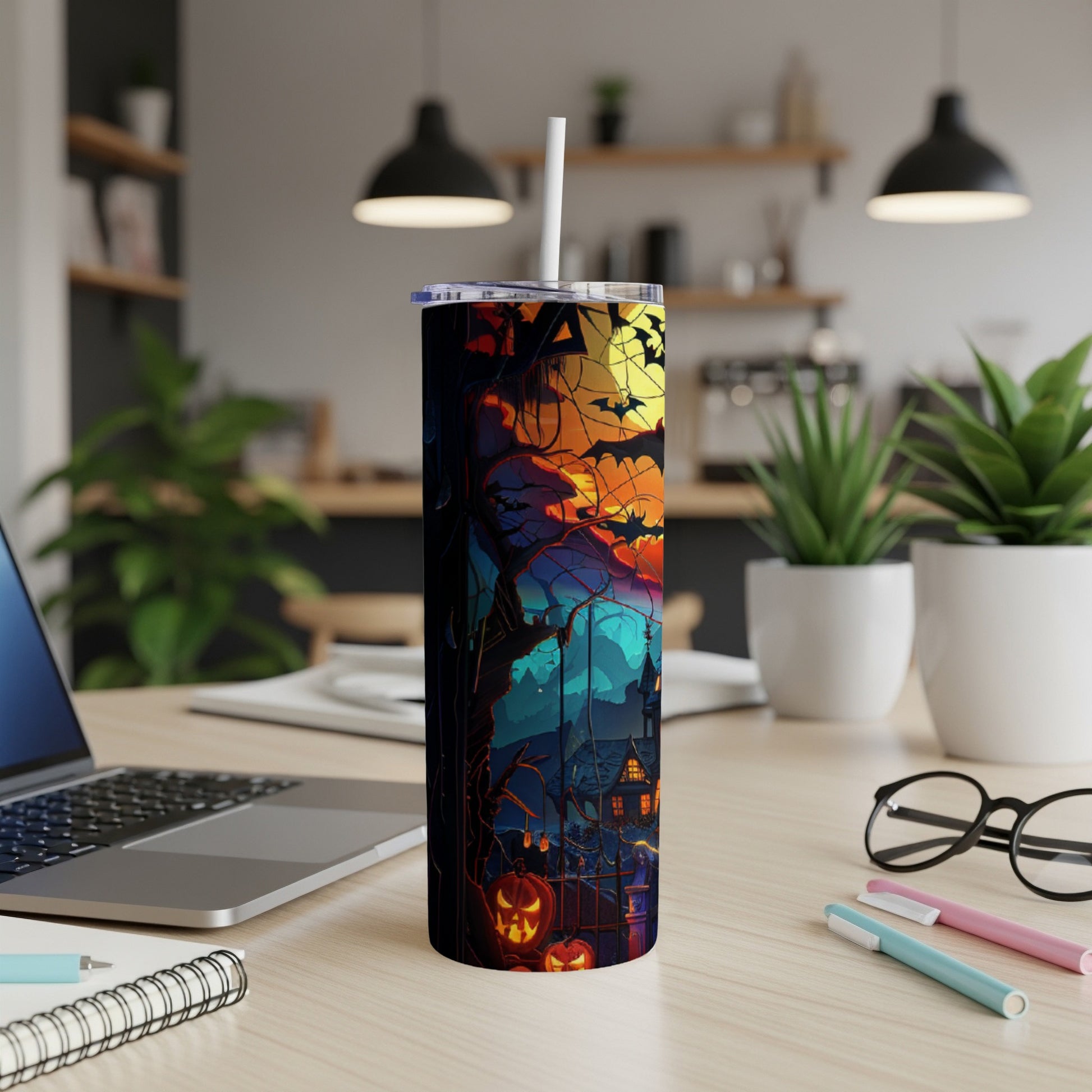 Halloween-themed tumbler with pumpkins, bats, and haunted house design.