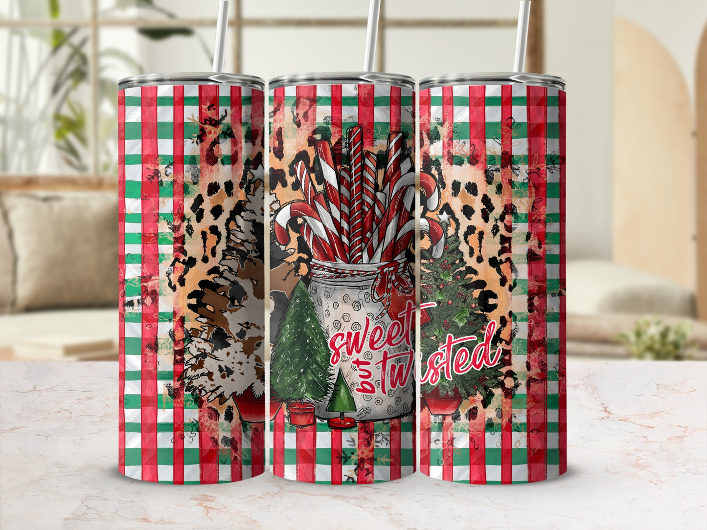 Three tumblers with candy cane, leopard print, and Christmas tree designs.