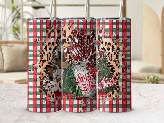 Three tumblers with candy cane, leopard print, and Christmas tree designs.