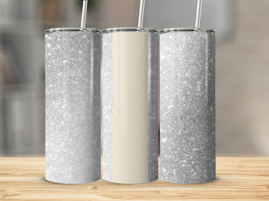 Three glittery tumblers with straws on a wooden surface.