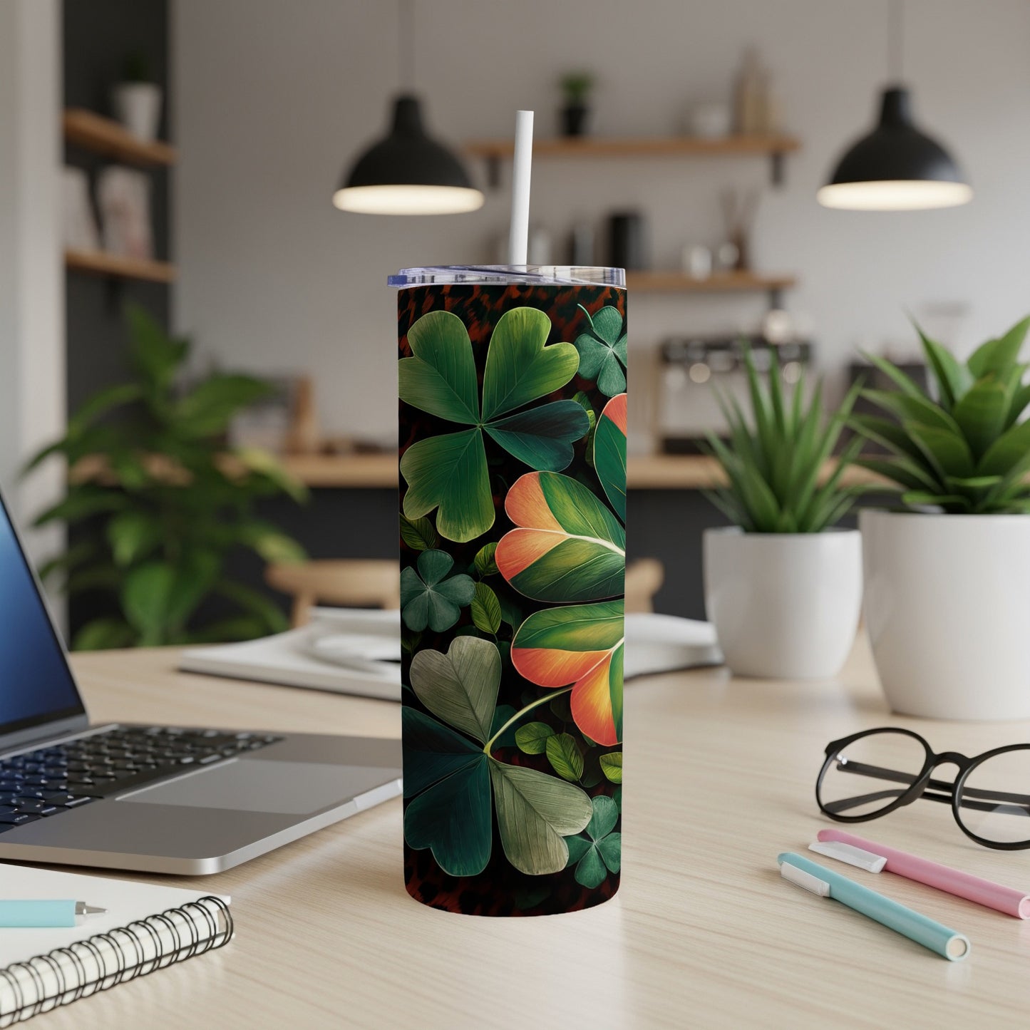 Green clover pattern on a stainless steel tumbler with a white straw.