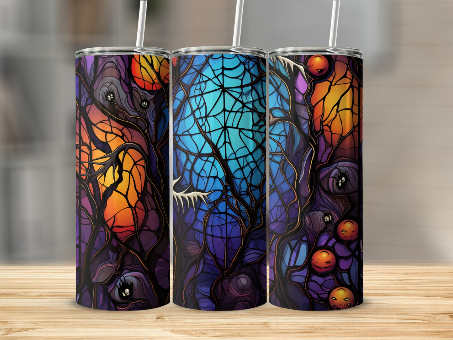 Three Halloween-themed tumblers with stained-glass style spooky trees and pumpkins.