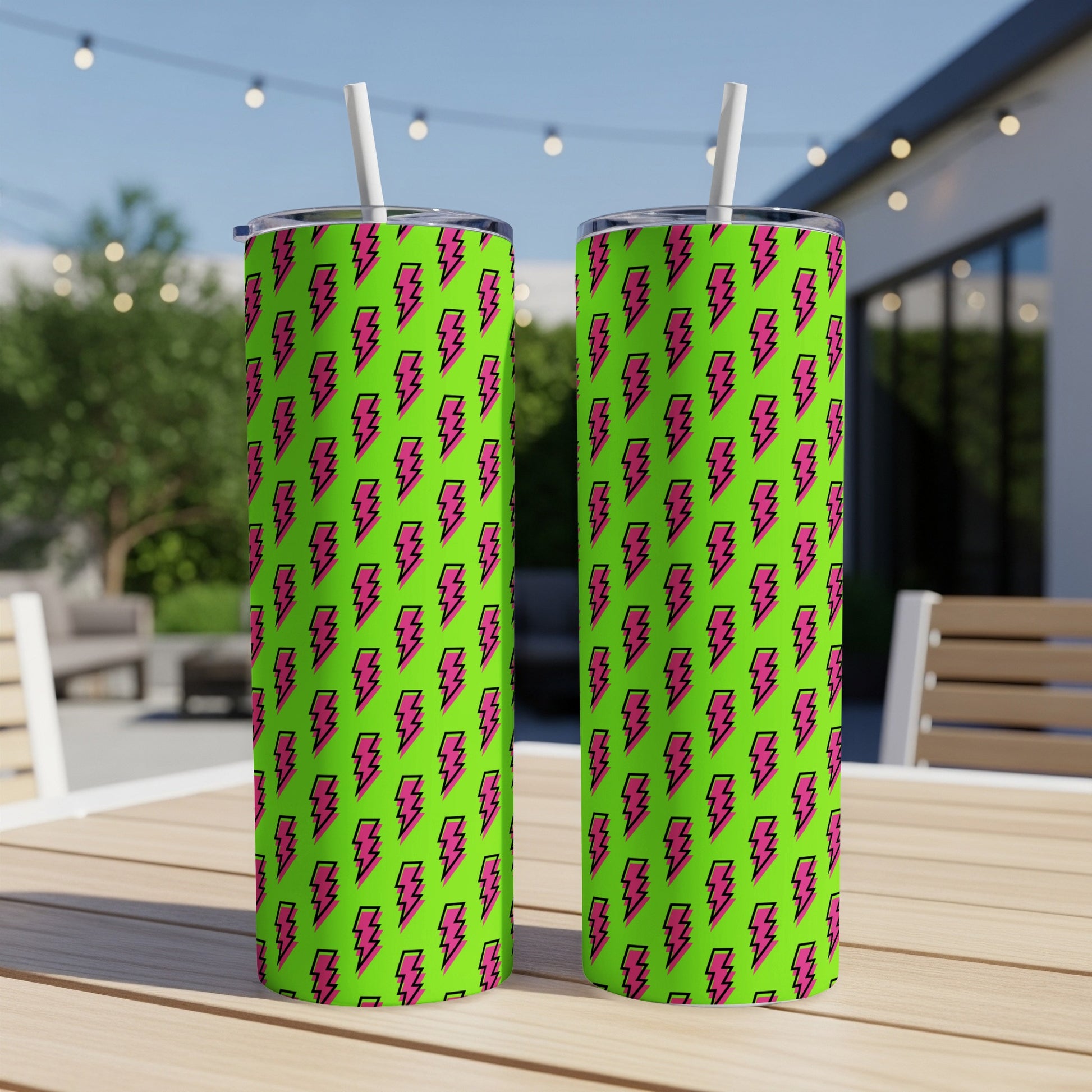 Two lime green tumblers with pink lightning bolt pattern, each with a white straw.