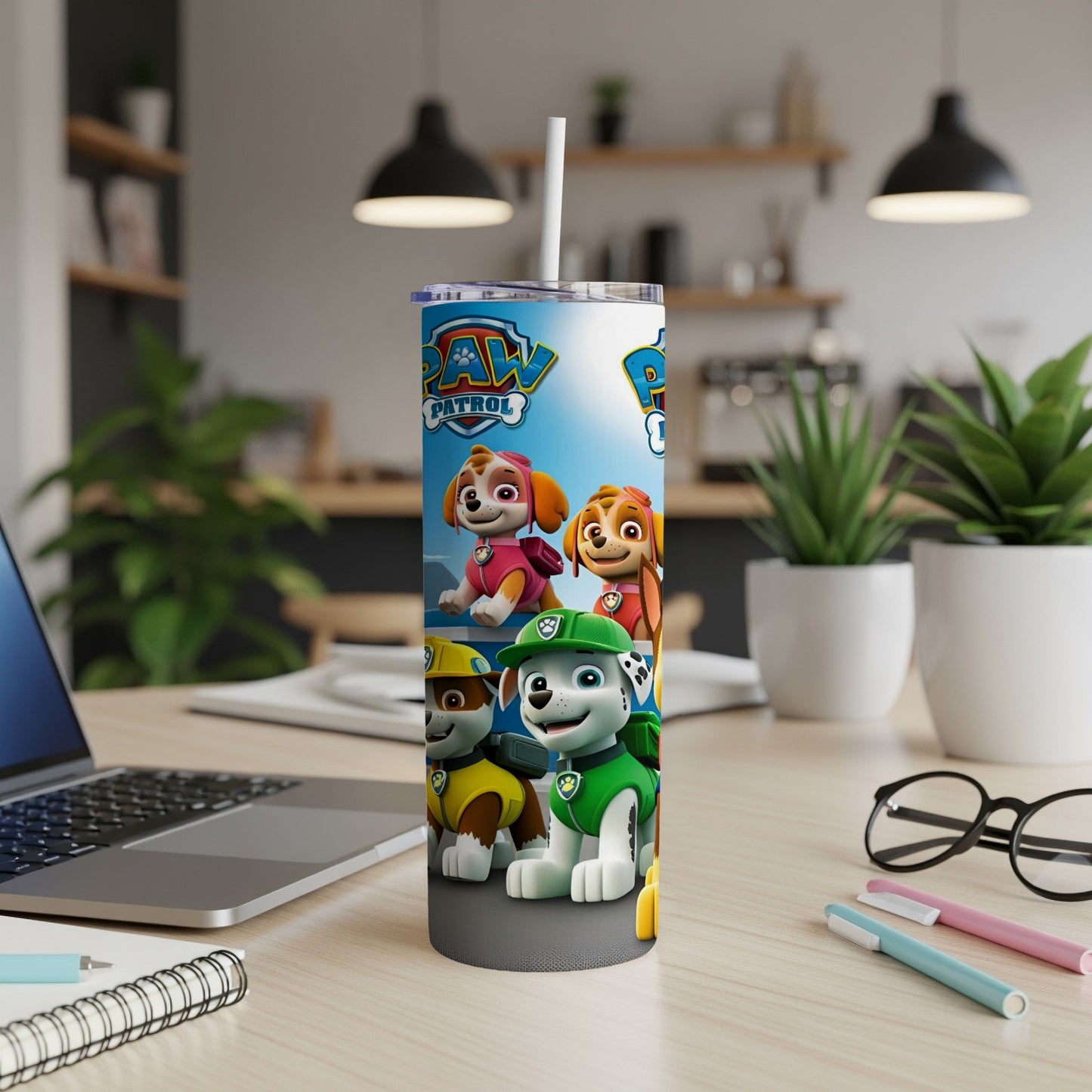 Paw Patrol characters Chase, Marshall, and Skye on a blue patterned tumbler.