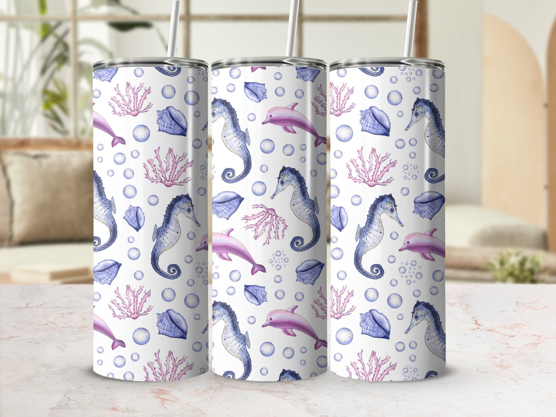 Three tumblers with a sea life pattern of seahorses, dolphins, shells, and coral.