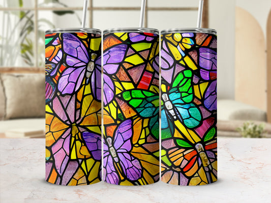 Three tumblers with stained-glass butterfly design and straws.