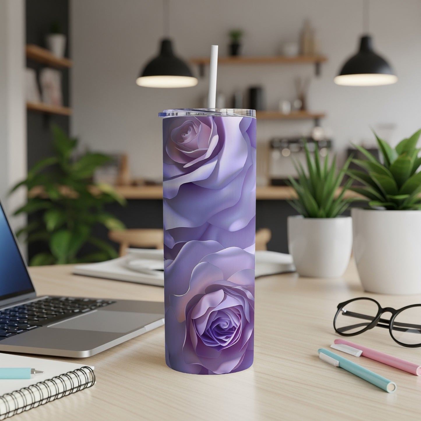 Purple rose floral pattern tumbler with straw on desk.