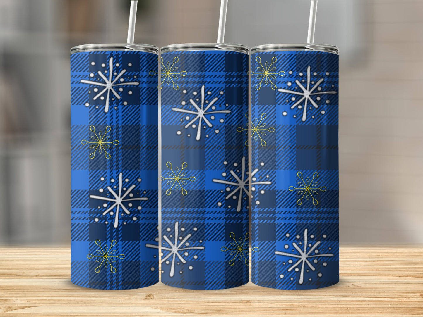 Blue plaid tumbler with white and yellow snowflakes, includes straw.