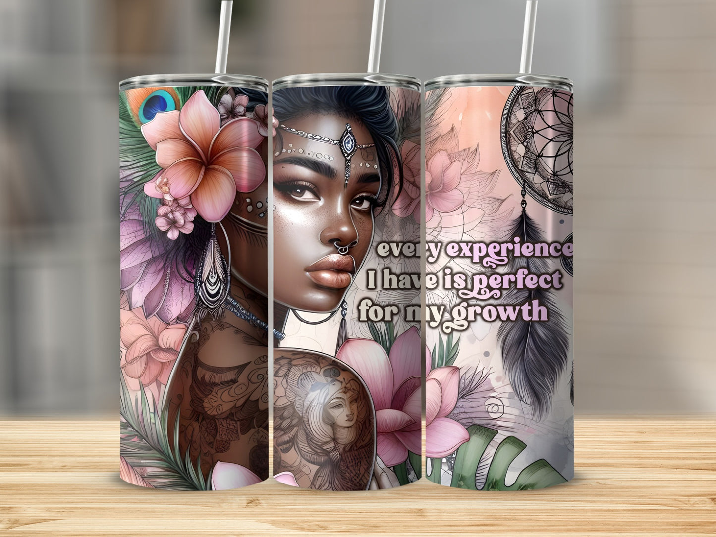 Three tumblers with floral and dreamcatcher designs, featuring tattooed women and inspirational text.