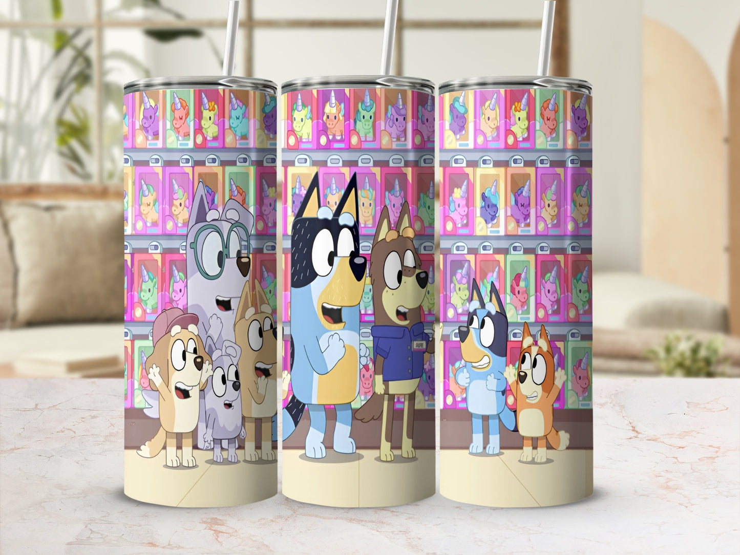 Bluey and Bingo characters on a colorful tumbler with unicorn designs.
