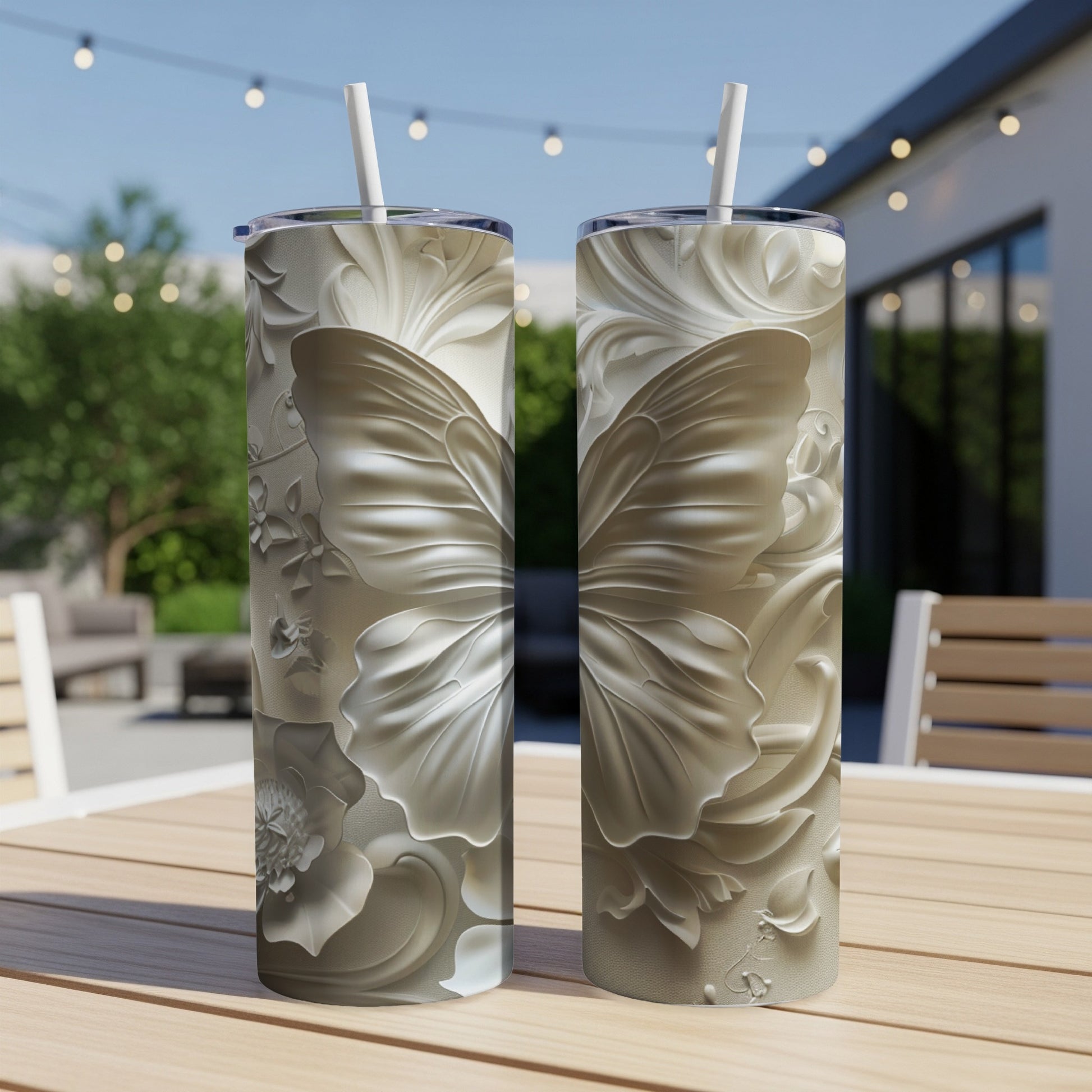 Two tall tumblers with embossed butterfly and floral designs.