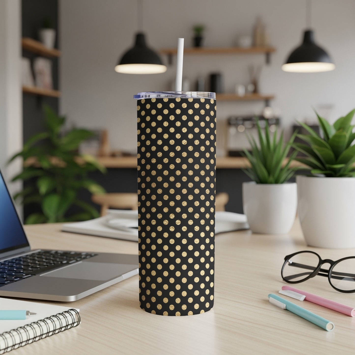 Black tumbler with gold polka dots and a white straw.