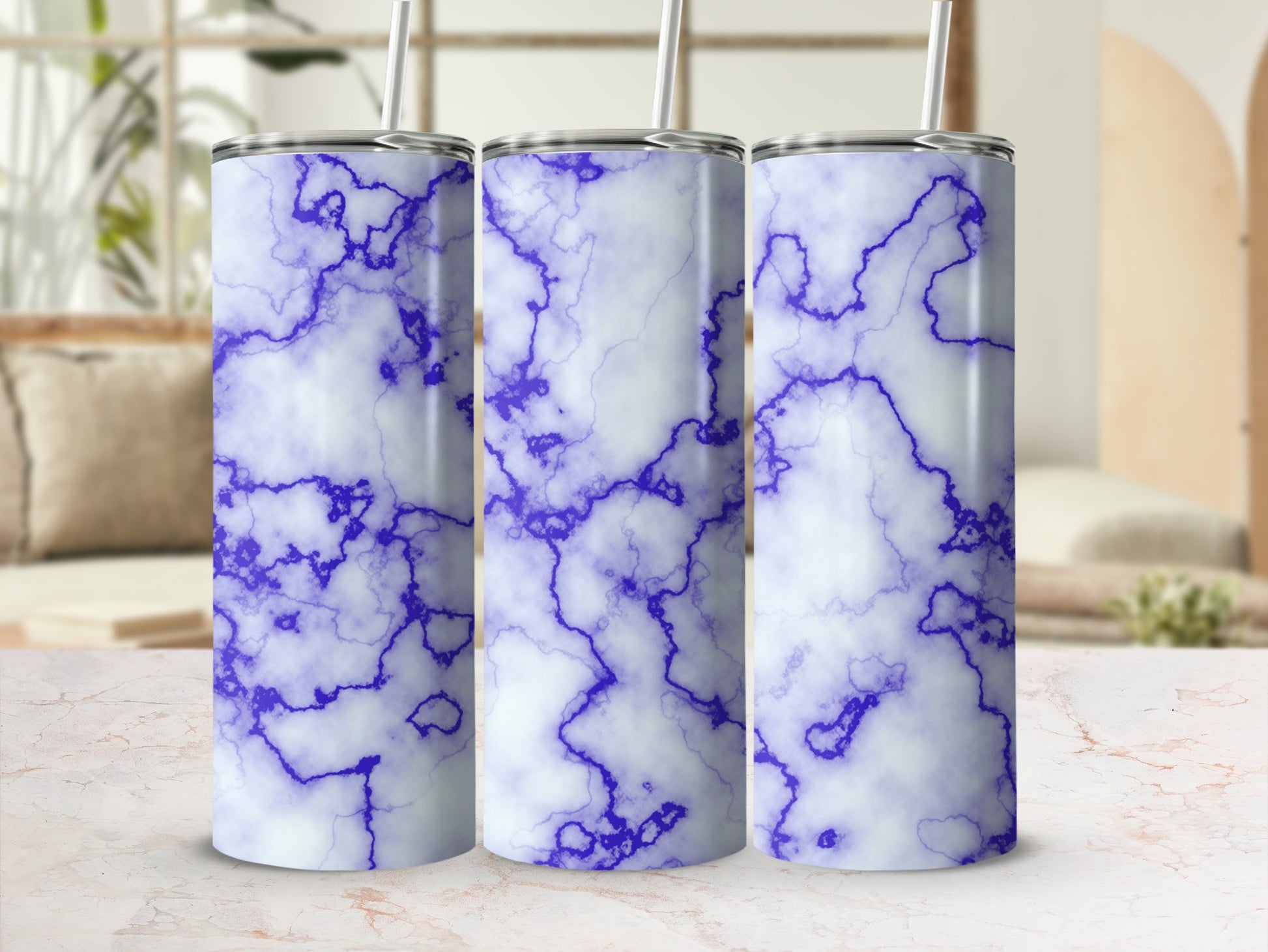 Three tall tumblers with a blue and white marble pattern and straws.