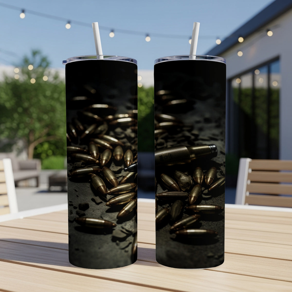 Two tumblers with a pattern of scattered brass bullet casings on a dark surface.
