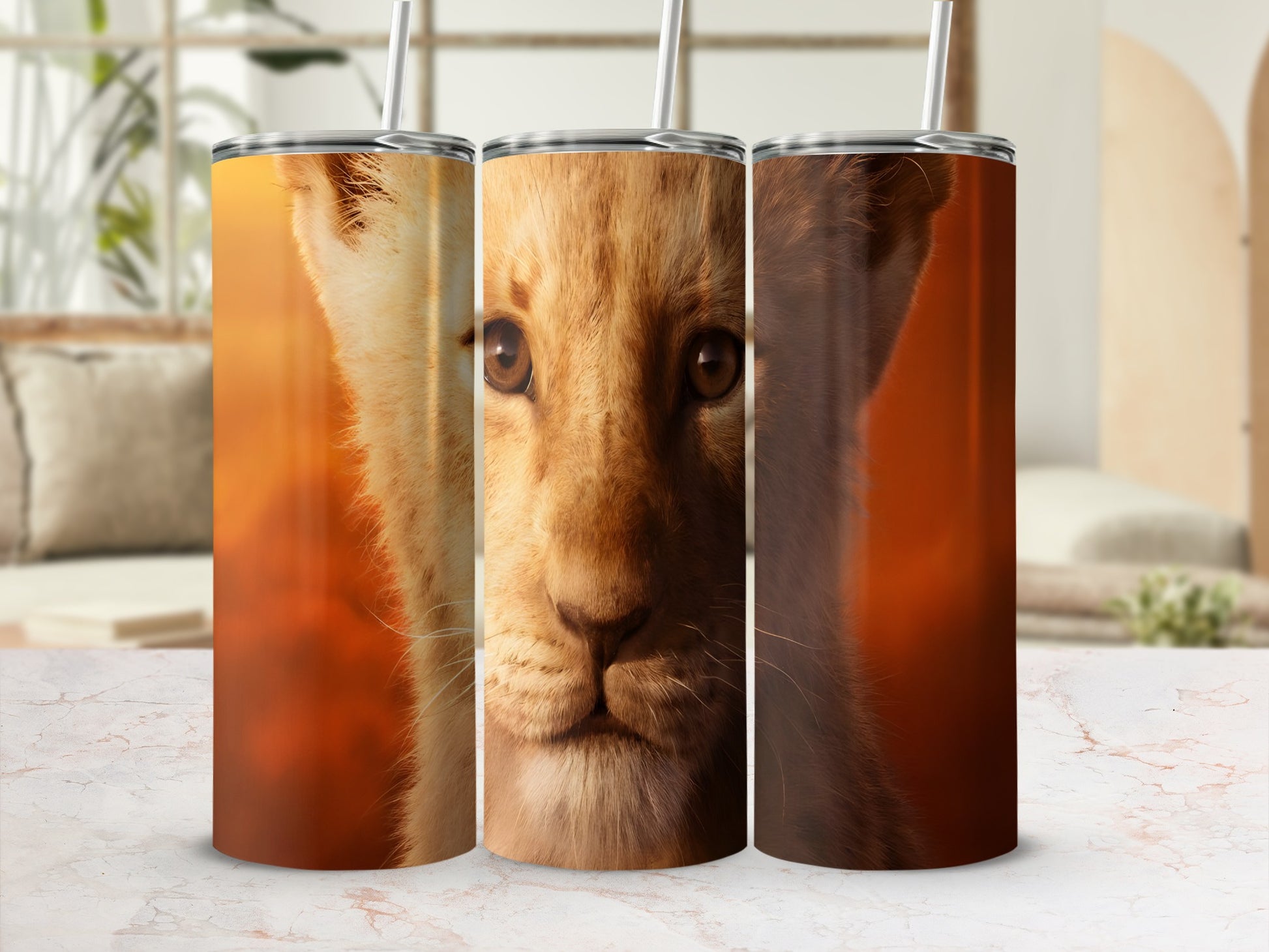 Close-up of a young lion's face on three tumblers.